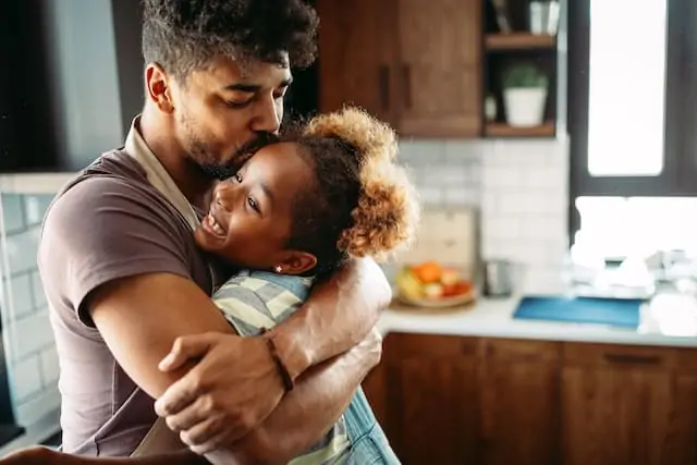 Parent hugging child shows the importance of hugging your child